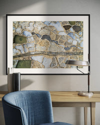 Salt Pans of Gozo, Malta, framed above a blue sofa
