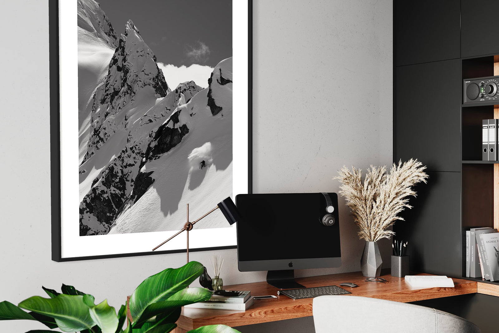 Tantalus 4 print framed above a desk with a monitor and plants