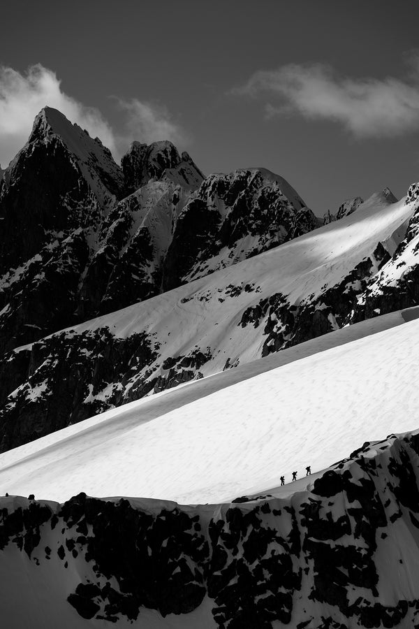 Back country skiers ascend in the Tantalus Range. Best Canadian wall art for luxury homes.