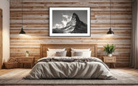Majestic Matterhorn print framed above a bed on a wood-panelled wall