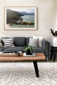 Howe Sound Passage framed print above a grey sofa in a modern living room