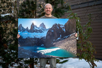 Mike Crane standing beside a large Laguna Sucia print