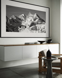 Icons of the Valais Alps panorama framed above a sideboard in a living room