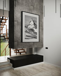Matterhorn and the Gornergrat print framed above a fireplace on a concrete wall