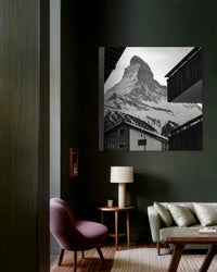 Zermatt Village print framed in a lounge with dark green walls